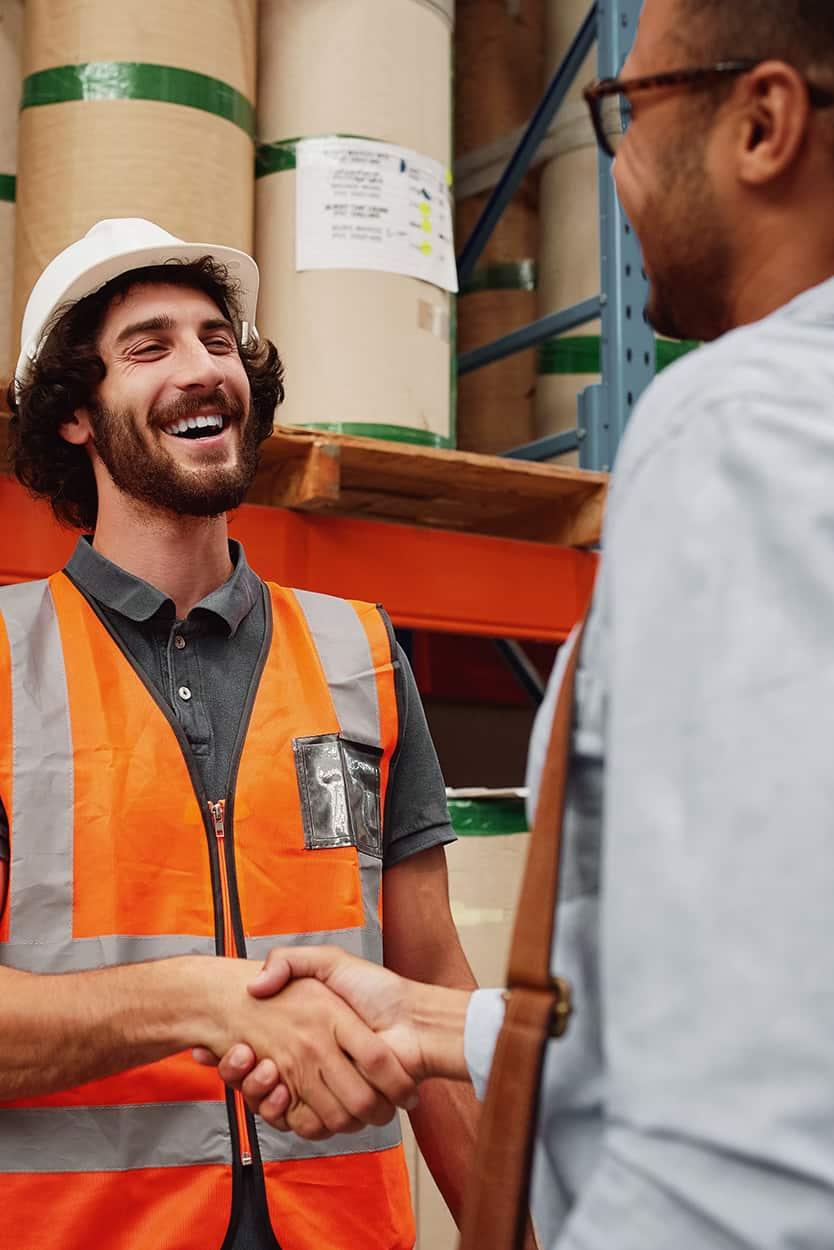 Warehouse Manager Shaking Hands With Business Partner | Schelkovskiy &Co Brennan Equipment Services