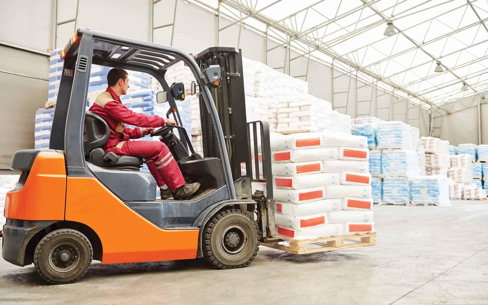 Orange Forklift With A Person Inside | Schelkovskiy &Co Brennan Equipment Services